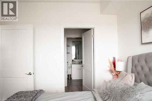 View of walk-in closet to the master bath - 255 Northfield Drive E Unit# 506, Waterloo, ON - Indoor Photo Showing Bedroom