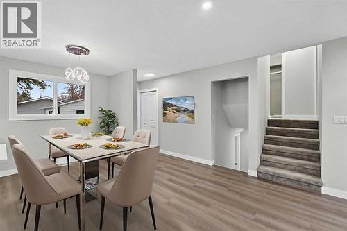 Virtually Staged - 127 Lynnview Way Se, Calgary, AB - Indoor Photo Showing Dining Room