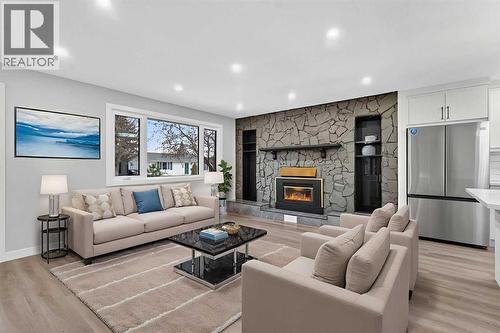 Virtually Staged - 127 Lynnview Way Se, Calgary, AB - Indoor Photo Showing Living Room With Fireplace