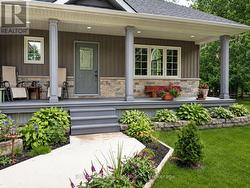 Charming covered porch and lovely landscaping - 