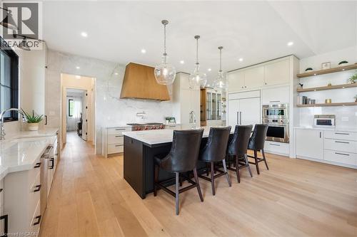 Kitchen featuring custom range hood, double oven, a sink, light wood-style flooring, and tasteful backsplash - 5020 First Line, Erin, ON - Indoor Photo Showing Other Room
