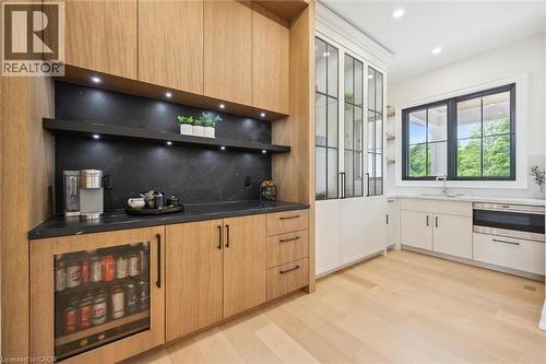 Kitchen with wine cooler, a sink, tasteful backsplash, light wood-type flooring, and open shelves - 5020 First Line, Erin, ON - Indoor Photo Showing Kitchen