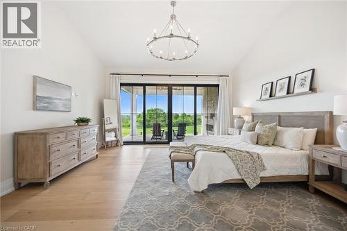 Bedroom featuring access to outside, a chandelier, light wood finished floors, and high vaulted ceiling - 5020 First Line, Erin, ON - Indoor Photo Showing Bedroom