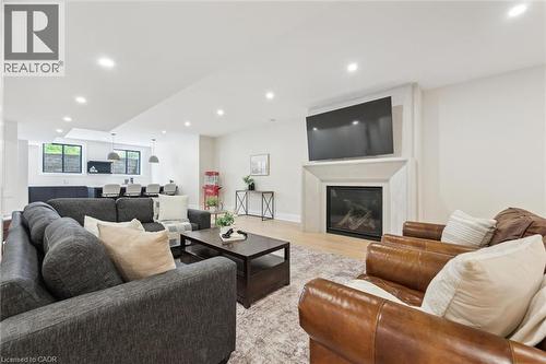 Living room featuring light wood-style flooring, recessed lighting, and a glass covered fireplace - 5020 First Line, Erin, ON - Indoor Photo Showing Living Room With Fireplace