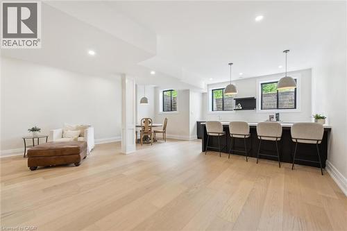 Kitchen with a breakfast bar, light wood-style flooring, recessed lighting, light countertops, and decorative light fixtures - 5020 First Line, Erin, ON - Indoor