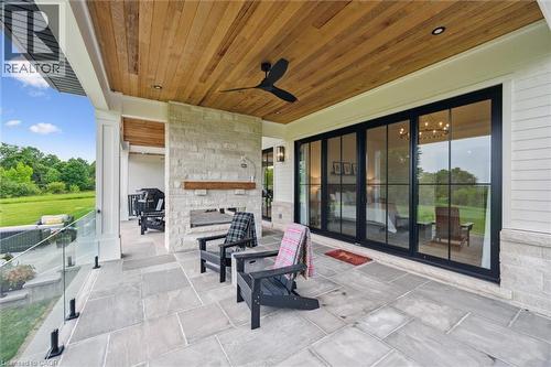 View of patio with an outdoor stone fireplace and a ceiling fan - 5020 First Line, Erin, ON - Outdoor With Exterior