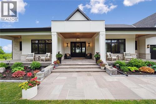 Doorway to property featuring a porch, an outdoor living space, stone siding, and french doors - 5020 First Line, Erin, ON - Outdoor With Deck Patio Veranda With Facade