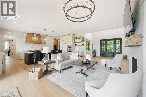 Living room featuring light wood-style floors, high vaulted ceiling, a chandelier, a fireplace, and recessed lighting - 5020 First Line, Erin, ON - Indoor Photo Showing Living Room