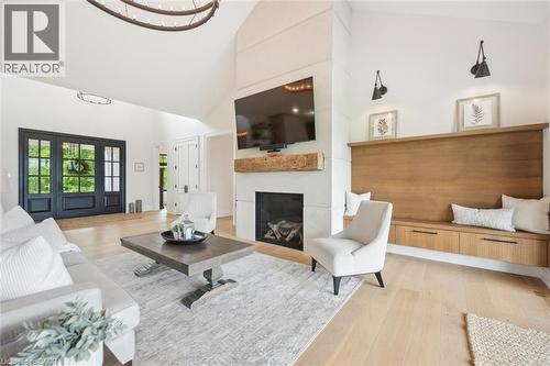 Living room with high vaulted ceiling, a fireplace, and light wood-type flooring - 5020 First Line, Erin, ON - Indoor Photo Showing Living Room With Fireplace