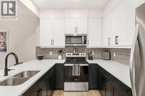 915 Crestridge Common Sw, Calgary, AB - Indoor Photo Showing Kitchen With Double Sink