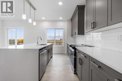 142 Sunstone Way, Balzac, AB - Indoor Photo Showing Kitchen With Upgraded Kitchen