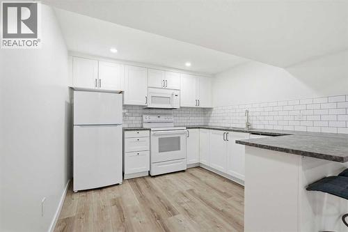 Illegal Suite 1-bed unit with full bathroom and washer and dryer - 711 101 Avenue Sw, Calgary, AB - Indoor Photo Showing Kitchen