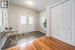 Entrance foyer with dark wood-type flooring and baseboards - 