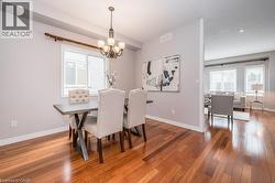 Dining area with light wood-style floors and a chandelier - 