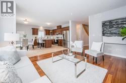 Living area featuring light wood-type flooring and stairs - 