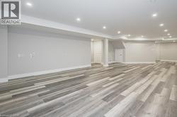 Finished below grade area featuring recessed lighting and light wood-style floors - 