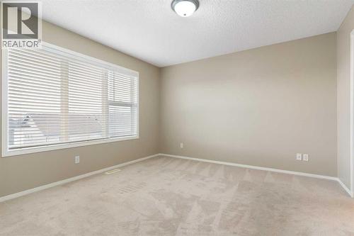 Primary bedroom, large window - 129 Evansbrooke Way Nw, Calgary, AB - Indoor Photo Showing Other Room