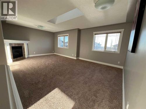 75 Royal Abbey Rise Nw, Calgary, AB - Indoor Photo Showing Other Room With Fireplace