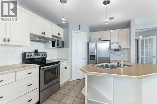 202 Schooner Close Nw, Calgary, AB - Indoor Photo Showing Kitchen With Stainless Steel Kitchen With Double Sink With Upgraded Kitchen