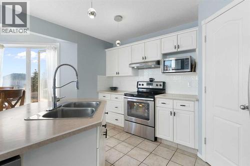 202 Schooner Close Nw, Calgary, AB - Indoor Photo Showing Kitchen With Stainless Steel Kitchen With Double Sink