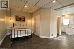 Bedroom with a drop ceiling and recessed lighting - 