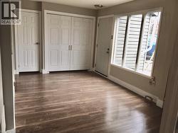 Unfurnished bedroom featuring dark wood finished floors and a closet - 