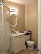 Bathroom featuring vanity, a stall shower, and light tile patterned floors - 