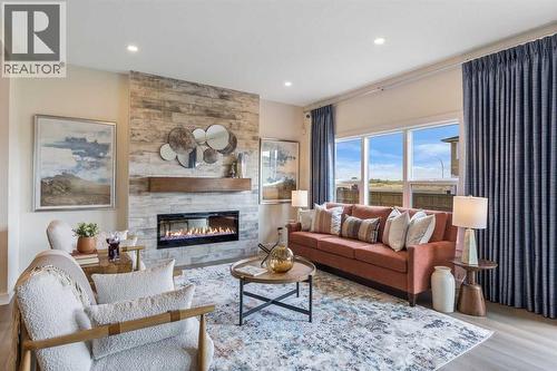 65 Emberside Grove, Cochrane, AB - Indoor Photo Showing Living Room With Fireplace