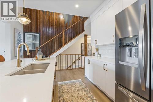 65 Emberside Grove, Cochrane, AB - Indoor Photo Showing Kitchen With Double Sink With Upgraded Kitchen