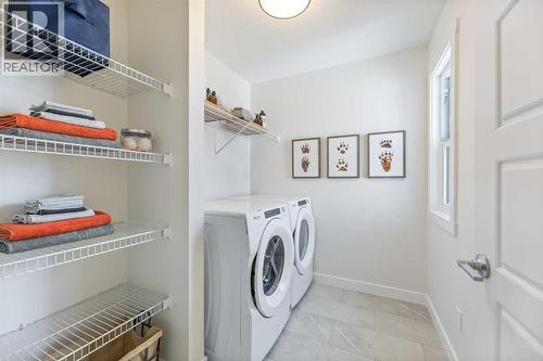 65 Emberside Grove, Cochrane, AB - Indoor Photo Showing Laundry Room