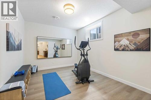 65 Emberside Grove, Cochrane, AB - Indoor Photo Showing Gym Room