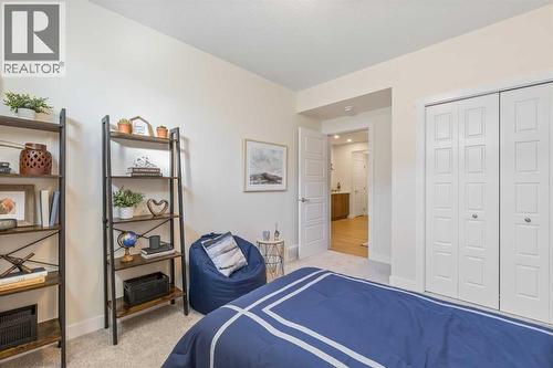 65 Emberside Grove, Cochrane, AB - Indoor Photo Showing Bedroom