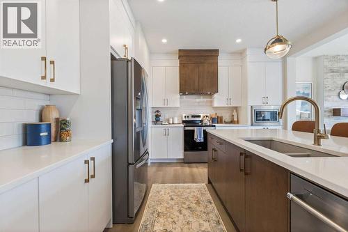 65 Emberside Grove, Cochrane, AB - Indoor Photo Showing Kitchen With Double Sink With Upgraded Kitchen