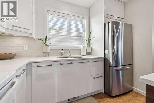 65 Tararidge Close Ne, Calgary, AB - Indoor Photo Showing Kitchen With Double Sink