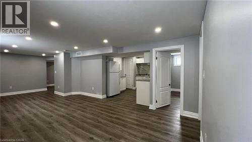 Unfurnished living room with dark wood-style flooring and recessed lighting - 29 Birchcliffe Crescent Unit# 2, Hamilton, ON - Indoor