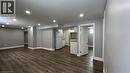 Unfurnished living room with dark wood-style flooring and recessed lighting - 29 Birchcliffe Crescent Unit# 2, Hamilton, ON  - Indoor 