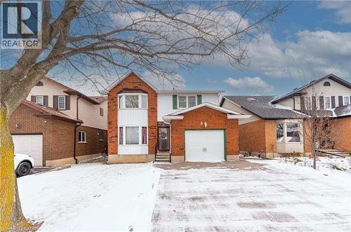 Traditional home with brick siding and a garage - 5 Charing Drive, Hamilton, ON - Outdoor With Facade