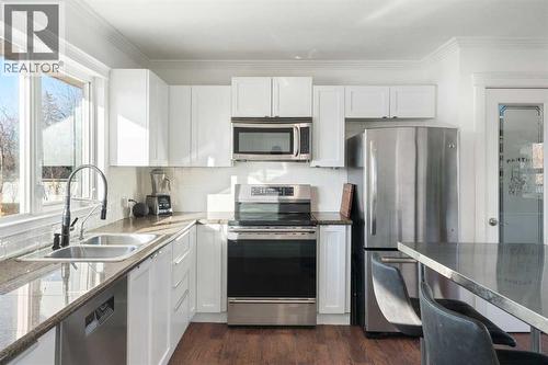 111 Macleod Trail E, Rural Foothills County, AB - Indoor Photo Showing Kitchen With Double Sink