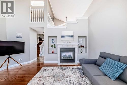 16feet high ceiling with skylight south face - 188 Hidden Ranch Crescent Nw, Calgary, AB - Indoor Photo Showing Living Room With Fireplace