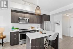 Kitchen with Quartz Counter Centre Island - 