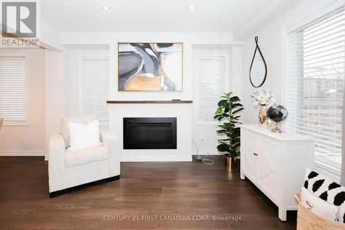 Freshly painted with neutral colors throughout. - 9 - 2040 Shore Road, London South (South A), ON - Indoor Photo Showing Living Room With Fireplace