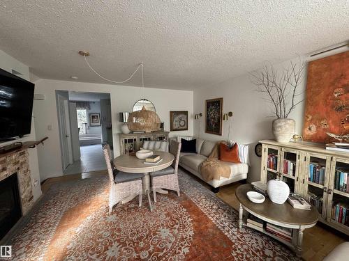 #208 178 Bridgeport Bv, Leduc, AB - Indoor Photo Showing Living Room With Fireplace