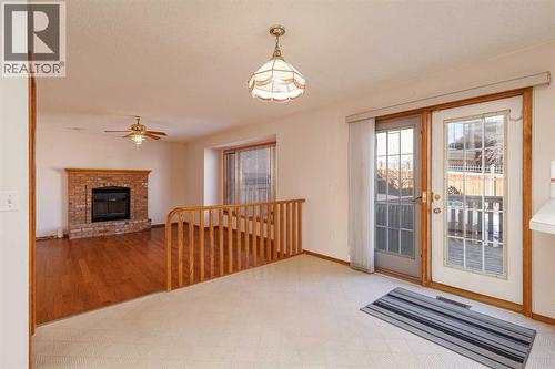 39 Signature Mews Sw, Calgary, AB - Indoor With Fireplace