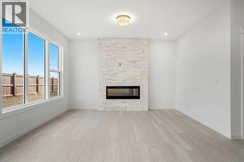 94 Cornerbrook Crescent Ne, Calgary, AB - Indoor Photo Showing Living Room With Fireplace