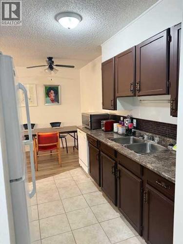 106, 11114 Hoppe, Grande Cache, AB - Indoor Photo Showing Kitchen With Double Sink