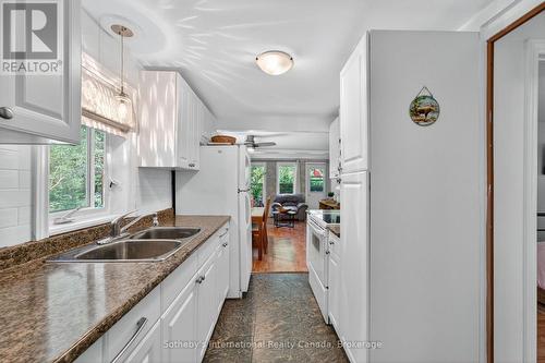 Galley kitchen overlooks side yard - 14 Domar Road, Tiny, ON - Indoor Photo Showing Kitchen With Double Sink