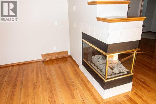 3-Way FP - 16 Eagleview Heights Nw, Cochrane, AB - Indoor Photo Showing Other Room With Fireplace