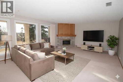 Family Rm - Virtual Staging - 16 Eagleview Heights Nw, Cochrane, AB - Indoor Photo Showing Living Room With Fireplace