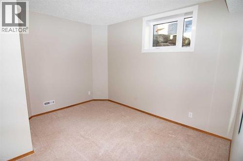 Guest Bed - Lower - 16 Eagleview Heights Nw, Cochrane, AB - Indoor Photo Showing Other Room