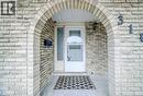 View of exterior entry featuring brick siding - 310 Magnolia Drive, Hamilton, ON 